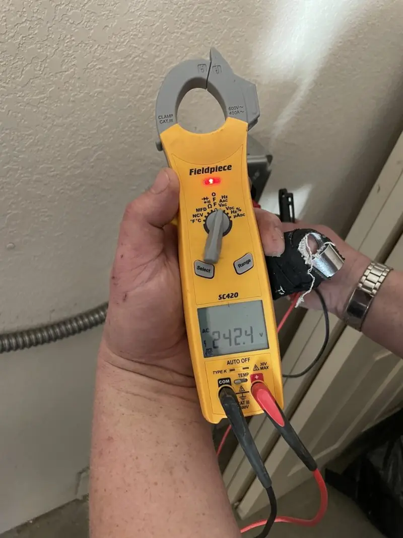 Voltage testing with clamp meter during Whole House Surge Protector in Moravia